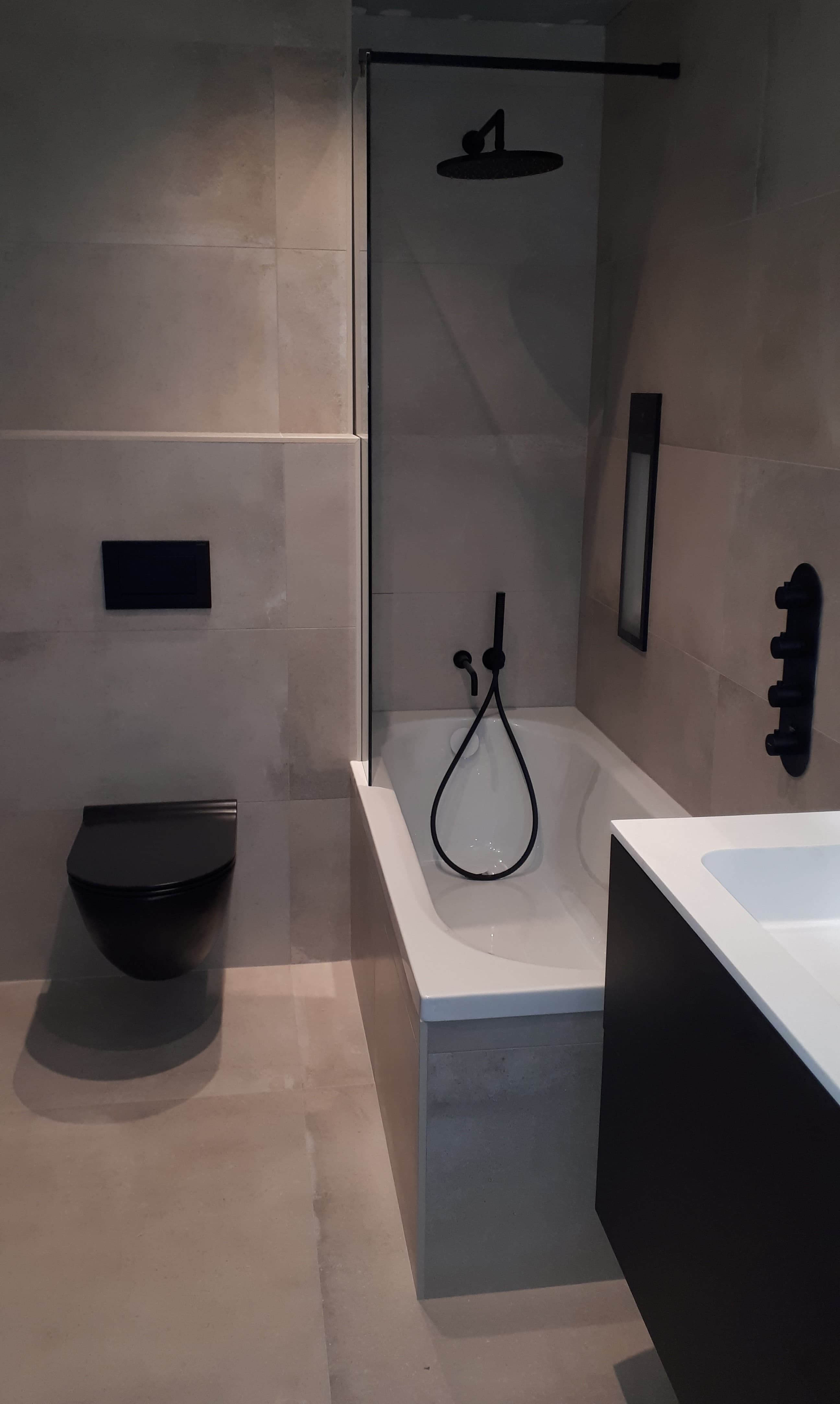Door De Keuster gerealiseerde badkamer met bad, hangtoilet en zwevend meubel